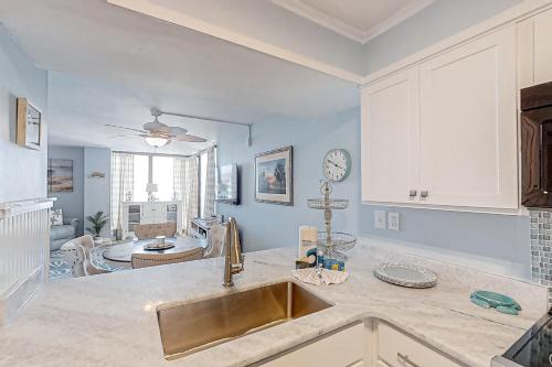 a kitchen with a sink and a living room at Sea Castle A-3 in Myrtle Beach