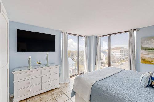 a bedroom with a bed and a large window at Sea Castle A-3 in Myrtle Beach