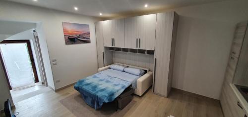 a small bedroom with a bed and a cabinet at Il Giardino Nascosto in Ascea