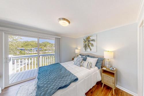 a bedroom with a bed and a balcony at Lands End in Myrtle Beach