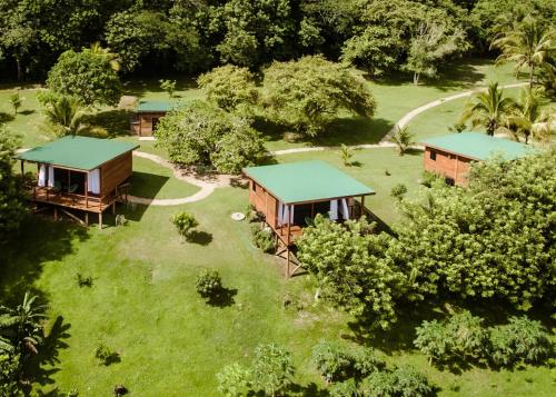 an aerial view of a resort with cottages at Yumas Riverfront Lodge in San Ignacio