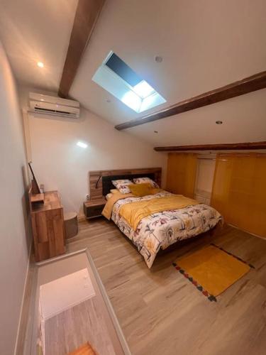 a bedroom with a bed and a skylight at T2 neuf et moderne climatiser avec Netflix amazon in Marseille
