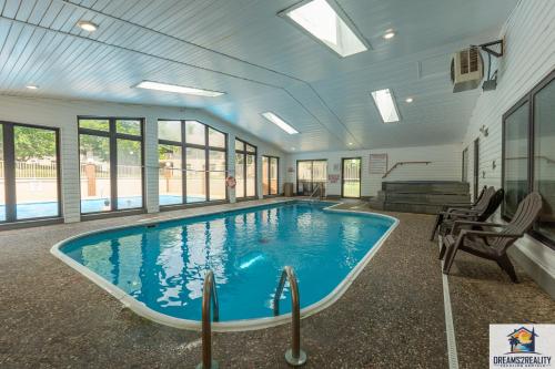 a large swimming pool in a building with windows at NEW BUILD - Walk-In - Resort Amenities - Near 76 Strip - FREE TICKETS INCLUDED - FH-G201 in Branson