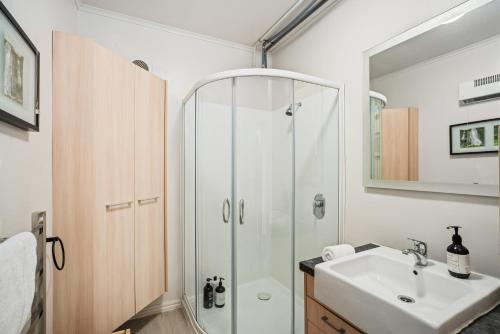 a bathroom with a shower and a sink at Awesomely Lakeview Queenstown Home in Queenstown