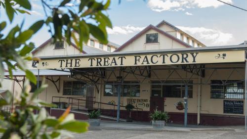 a building with a sign that reads the treat factory at The Red Barn right in the heart of historic Berry in Berry