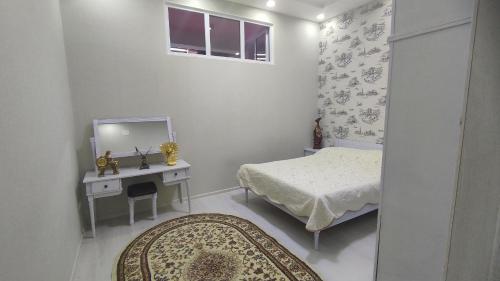 a small bedroom with a bed and a mirror at Уютная трёхкомнатная для семьи in Dushanbe