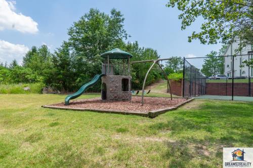 a playground with a slide in a yard at 2BR Walk-In Condo - Near The Strip - FREE TICKETS INCLUDED - CH1-18 in Branson