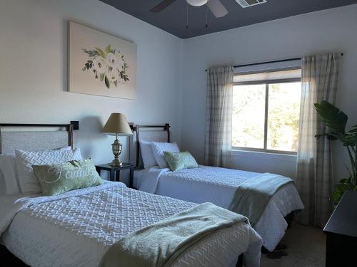a bedroom with two beds and a window at Lakeland Casita in Point Venture Optional Golf cart in Lago Vista
