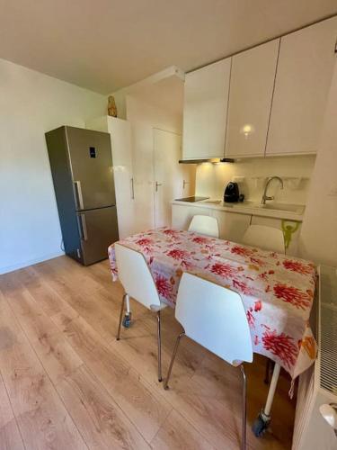 a kitchen with a table and chairs in a room at La vie est belle! in Hyères