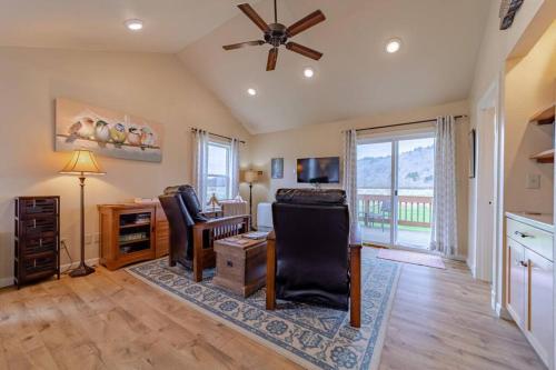 a living room with a ceiling fan and a desk at Elk Meadow Cabins Ranch Site Oreq-B in Orick