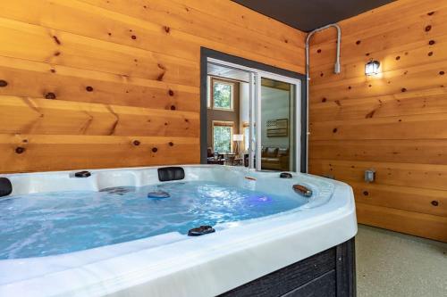 a hot tub in a room with a wooden wall at Cozy cabin in Ellijay, near Blue Ridge ! in Ellijay