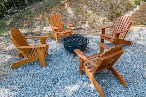 three wooden chairs sitting next to a fire pit at Cozy cabin in Ellijay, near Blue Ridge ! in Ellijay