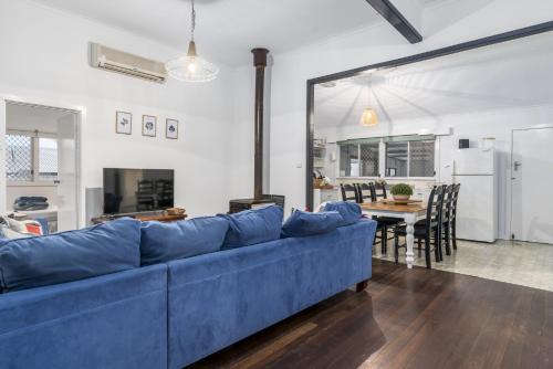 a blue couch in a living room with a table at Family Fun Your beach and fishing delight in Rockingham
