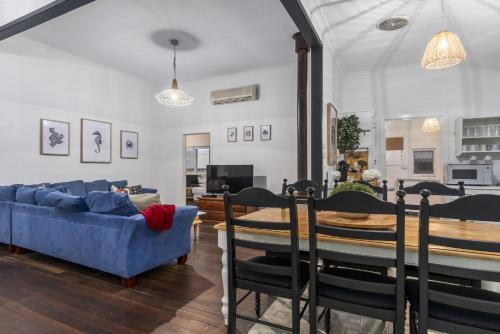 a living room with a blue couch and a table at Family Fun Your beach and fishing delight in Rockingham