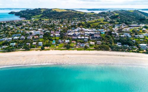 an aerial view of a beach with houses at Oneroa Central - Coast & Country in Oneroa
