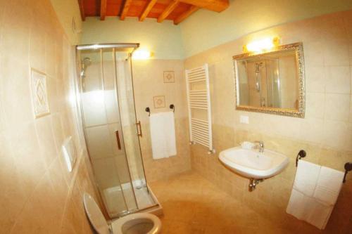 a bathroom with a shower toilet and a sink at La Ginestra in Orentano