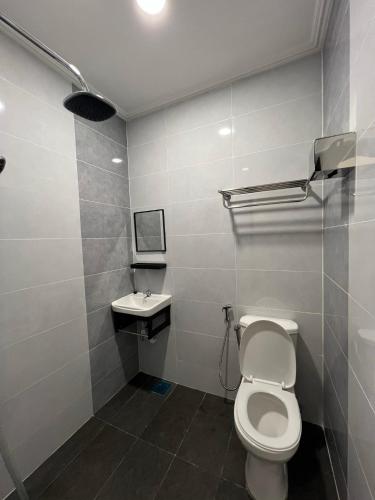 a bathroom with a toilet and a sink at Dey Hotel Kota Bharu in Kota Bharu