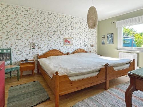 a bedroom with a wooden bed in a room at 5 person holiday home in VISBY-By Traum in Visby