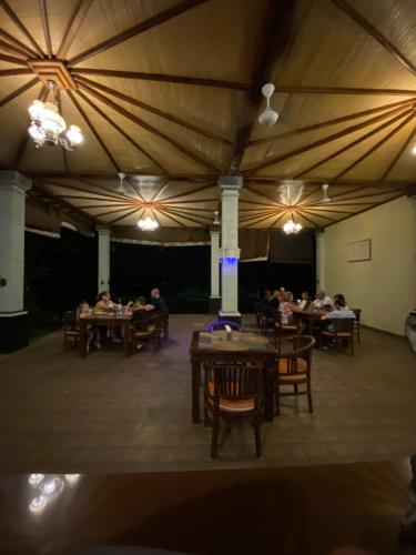 a group of people sitting at tables in a tent at Bali Bhuana Villas in Amed