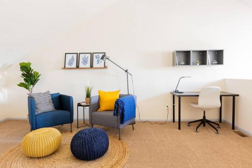 a room with two chairs and a desk and a table at Cozy 2BR condo w/ valley views in Vernon Township
