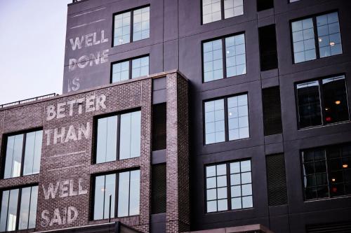 a building with a sign on the side of it at The Junto Hotel in Columbus