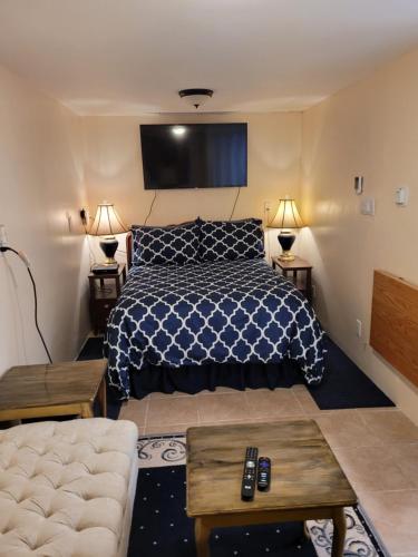 a bedroom with a bed and a couch at Noble Waterfront Suites in Brockville