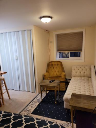 a living room with a couch and a table at Noble Waterfront Suites in Brockville