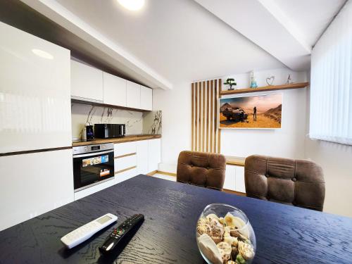 a kitchen with a table with a bowl of food on it at Apartment Varna in Varna City