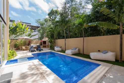 a swimming pool in the backyard of a house at Tulum Private Modern Villa-Pool Beds-AC-Internet-Parking-Grill in Tulum