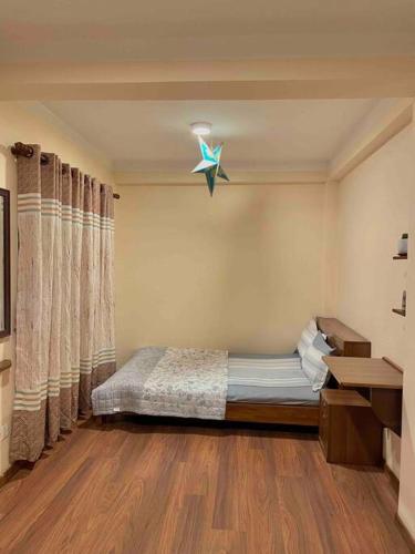 a bedroom with a bed and a star on the wall at In the heart of Patan Durbar Square in Pātan