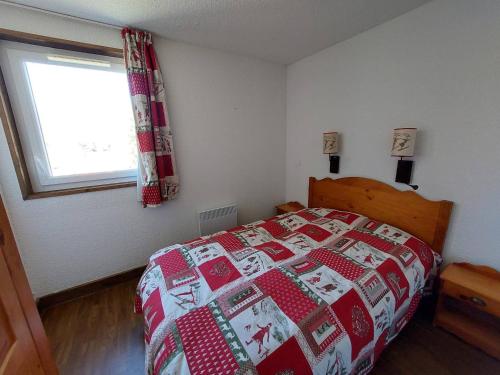 a bedroom with a christmas quilt on a bed at Appartement Autrans-Méaudre en Vercors-Autrans, 2 pièces, 4 personnes - FR-1-737-24 in Autrans