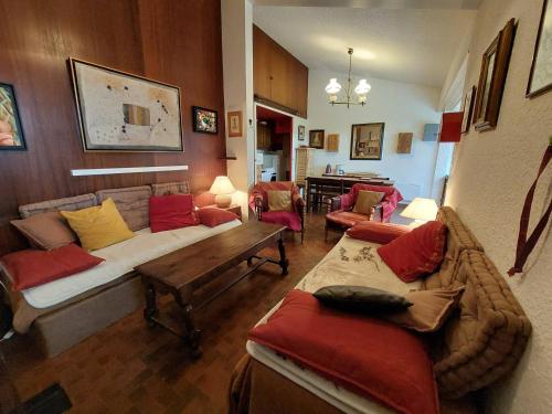 a living room with a couch and chairs and a table at Maison Autrans, 3 pièces, 4 personnes - FR-1-737-41 in Autrans