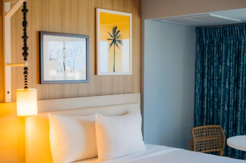a hotel room with a bed and a table at Waikiki Malia in Honolulu
