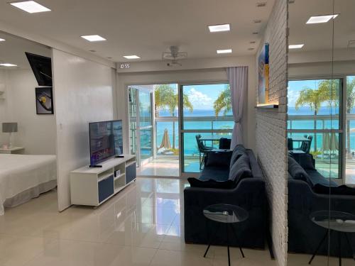 a living room with a tv and a couch and a bed at Apto VISTA MAR na Av Contorno in Salvador