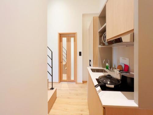 a kitchen with a sink and a counter at Coliwoo 298 River Valley - CoLiving in Singapore