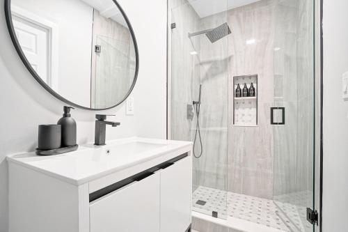 a bathroom with a shower and a sink and a mirror at Miami Lux Vacations - Villa in Miami