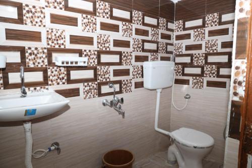 une salle de bain avec toilettes et lavabo dans l'établissement Hello India home stay, à Khajurâho