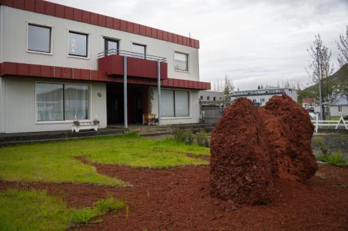 a large pile of dirt in front of a building at Cosy Studio Apartment in Hveragerði