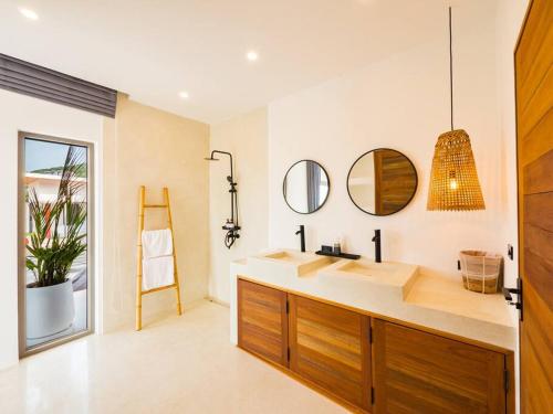 a bathroom with a sink and mirrors on the wall at Villa Dila 3 bed Elephant Haven! in Koh Samui