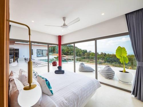 a bedroom with a bed and a large window at Villa Dila 3 bed Elephant Haven! in Koh Samui