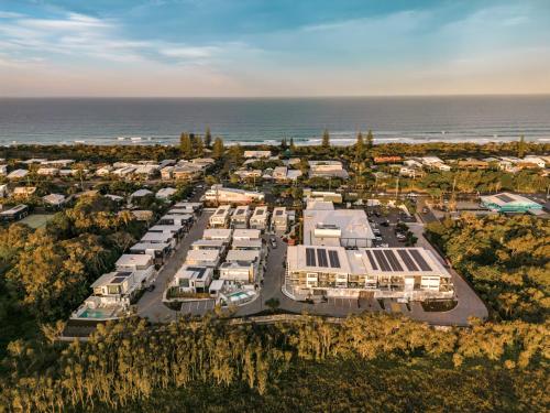 an aerial view of a parking lot next to the ocean at Essence Peregian Beach in Peregian Beach