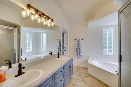 uma casa de banho com 2 lavatórios e uma banheira e um tubermott em Casa Blanco Florida Escape Pool, Fire Pit and Grill em Sebastian