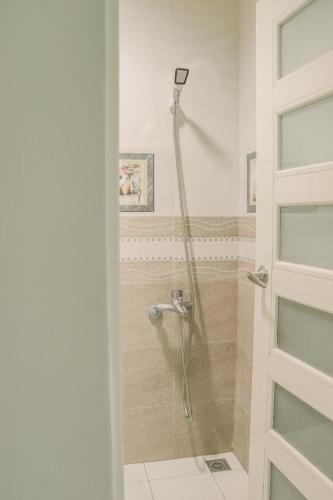 a bathroom with a shower with a glass door at TETE Homestay in Xiaoliuqiu
