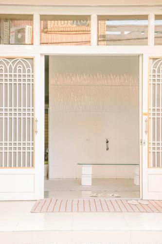 an open door of a building with a bench inside at TETE Homestay in Xiaoliuqiu