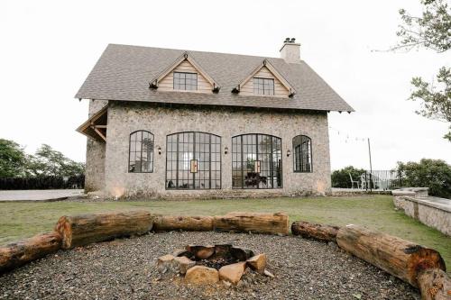 a house with a fire pit in front of it at The Old Country Stone House in Cebu City