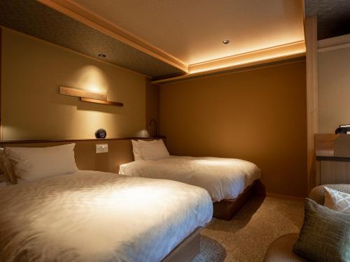 - une chambre d'hôtel avec 2 lits dans l'établissement Arima Grand Hotel, à Kobe
