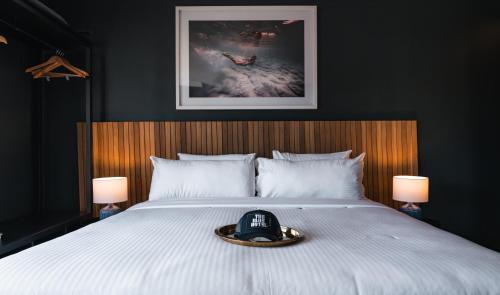 a bedroom with a bed with a phone on it at The Blue Hotel Bondi in Sydney