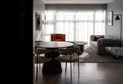 a living room with a table and a couch at Salamanca Suites in Hobart