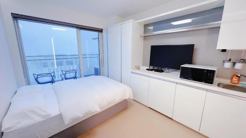 a bedroom with a bed and a large window at Shine Hotel Incheon Airport in Incheon