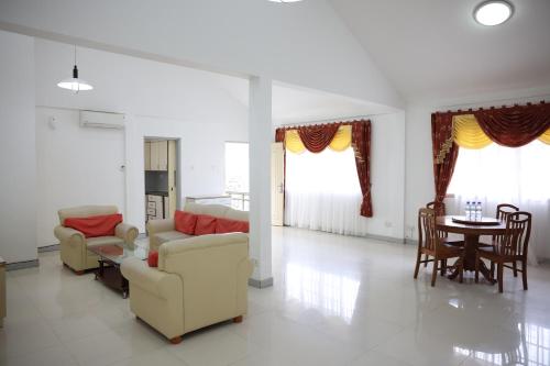 a living room with two couches and a table at Bintan Service Apartment in Sebungsungai